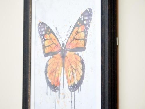 a butterfly painted on the glass of a window at Swan Hotel by Greene King Inns in Alton