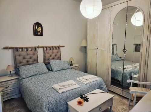 a bedroom with a large bed and a mirror at Appartamento Citara in Ischia