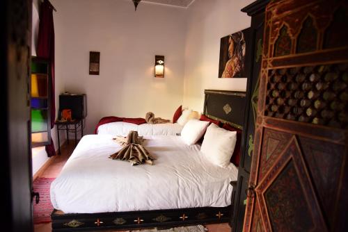 a bedroom with two beds with skeletons on the bed at Riad Du Petit Prince in Marrakesh