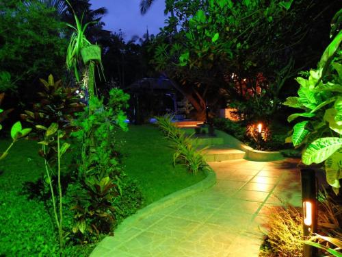 a garden at night with a walkway at Palmhill Villa in Boracay