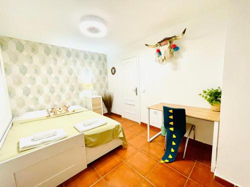 Habitación pequeña con cama, escritorio y escritorio. en Welcome Málaga, en Málaga