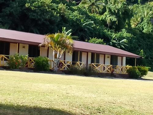 a building with a palm tree in front of it at Waya Lailai Eco Haven in Wayasewa Island