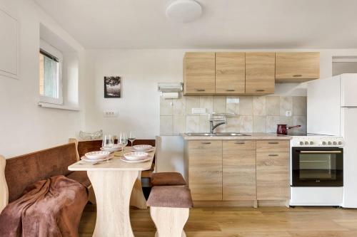 a small kitchen with a table and a counter top at Nature Cottage in Gabrce with sauna in Rogaška Slatina