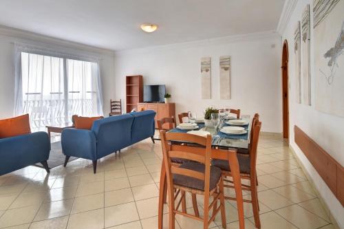 a dining room and living room with a table and chairs at Unique Seaview Apartments and Penthouse in Central St Julians in St Julian's