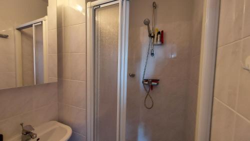 a bathroom with a shower with a toilet and a sink at Zeedijk Koksijde in Koksijde