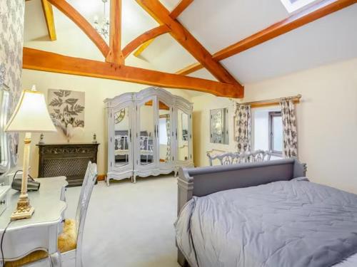 a bedroom with a bed and a table and chairs at Rookery barn in the outskirts of darley in Harrogate