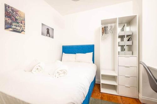 a white bedroom with a bed and a closet at Central 2 Bedroom Apartment - South Street - St Andrews in St. Andrews