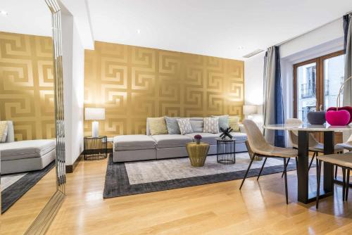 a living room with a couch and a table at Luxury apartment in the center Gran Via Colon in Madrid
