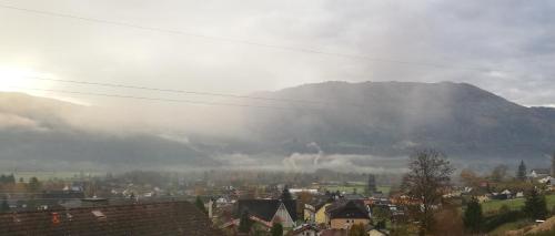 a view of a city with a mountain in the background at Ferienwohnung BergTime in Weißenbach bei Liezen