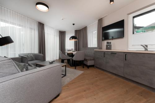 a living room with a couch and a tv at A Casa Elements in Serfaus