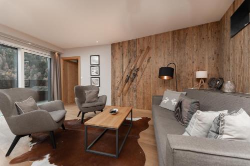 a living room with a couch and chairs and a table at A Casa Elements in Serfaus