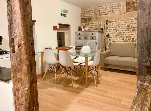 a kitchen and dining room with a table and chairs at Lovely appartment in Voeren in Voeren