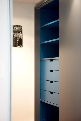 a cabinet with blue drawers in a room at Periscope in Athens