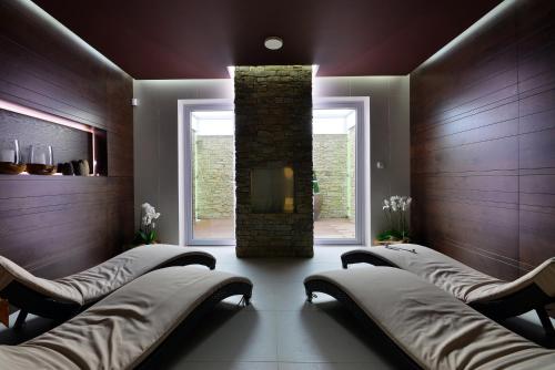 a spa room with four chairs and a fireplace at Hotel Harmony Medical & Wellness-Free Parking, 1,8km from the center in Kroměříž