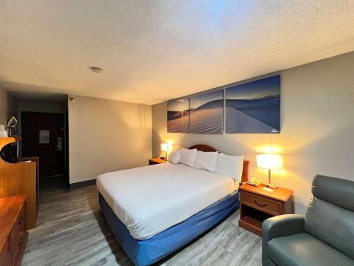 a hotel room with a bed and a couch at Antelope Inn & Suites in Clearfield