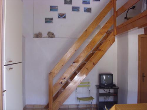 ランペドゥーザにあるLe Pietre Di Lampedusaのテレビ付きの客室内の木製階段