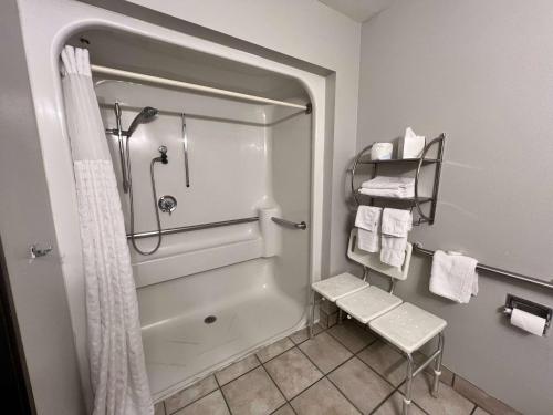 a bathroom with a shower and a shower curtain at Antelope Inn & Suites in Clearfield