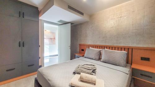 a bedroom with a bed with a wooden headboard at Yalikavak Twin Villa in Bodrum City