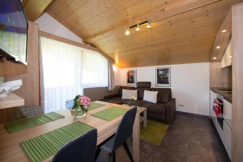 a living room with a table and a couch at Appartements Schneezauber in Lermoos