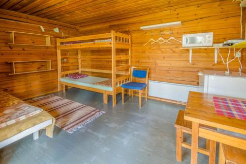 a cabin with a bunk bed and a table and chair at Ahvenlampi Camping Hostel in Saarijärvi