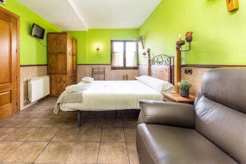 a large room with two beds and a couch at PERRATZU LANDARBIDE-Ideal parejas in Aia