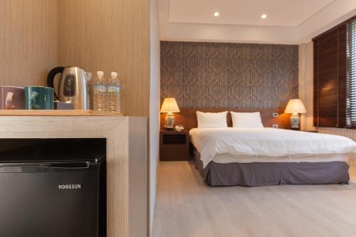 a hotel room with a bed and a fireplace at Lanven Art House in Hualien City