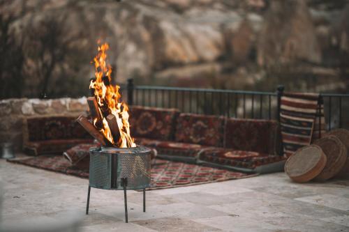 a fire pit with a couch and an american flag at DAPHNE CAVE HOTEL in Avanos
