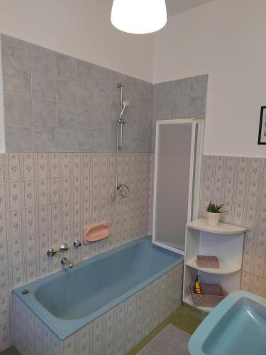 a bathroom with a blue tub and a sink at Lomello_Free Wi-Fi_Netflix in Lomello