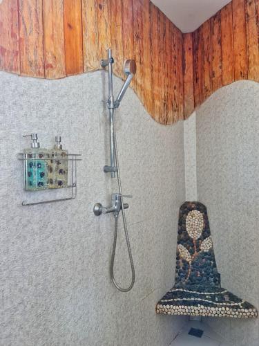 a shower in a bathroom with a chair in it at Tamnanpar Resort in Ban Phe