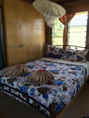 a bed with blankets and pillows on top of it at Waya Lailai Eco Haven in Wayasewa Island