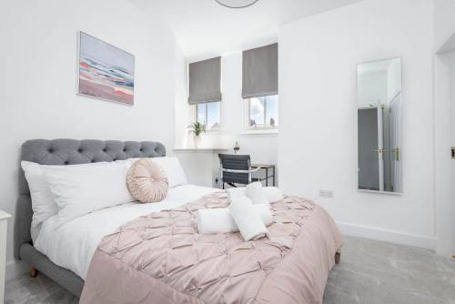 a bedroom with a large bed with pillows on it at Skye Sands - Old Course Residence in St. Andrews