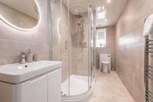 a bathroom with a shower and a sink and a toilet at Skye Sands - South Street Residence - St Andrews in St. Andrews
