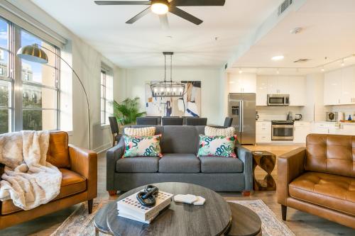 a living room with a couch and a table at Spacious 4-Bed Condo steps from French Quarter in New Orleans