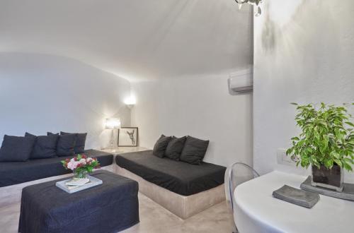 a living room with a couch and a table at Arvanitis Cave Village in Akrotiri