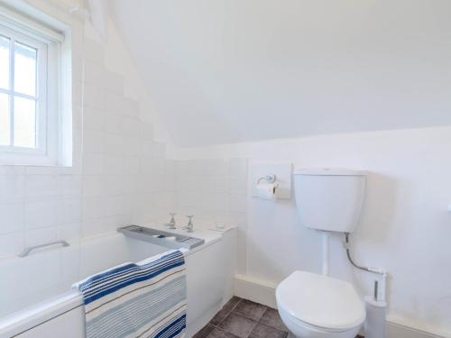 a white bathroom with a toilet and a sink at 3 Bed in Kiplin 79275 in Great Langton