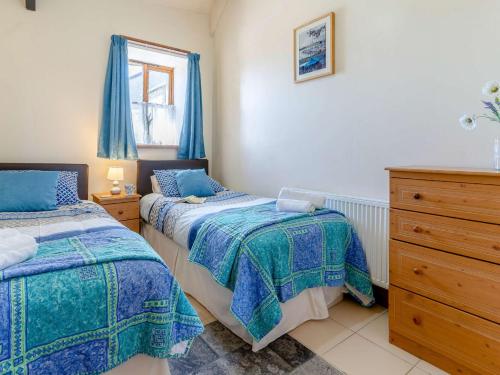 a bedroom with two beds and a dresser at 1 bed property in Brynteg 81354 in Llanwenog