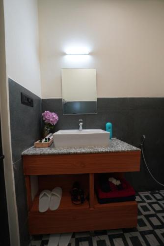 a bathroom with a sink and a mirror at The Solace Bir in Bīr
