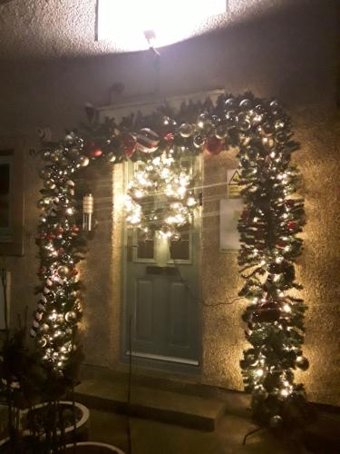 a house with christmas lights and a door at Levens Terrace, Barrow Spa Therapy in Barrow in Furness