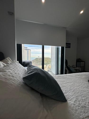almohada en la parte superior de una cama con ventana en E1 Apartment High Level Sea View en Gibraltar