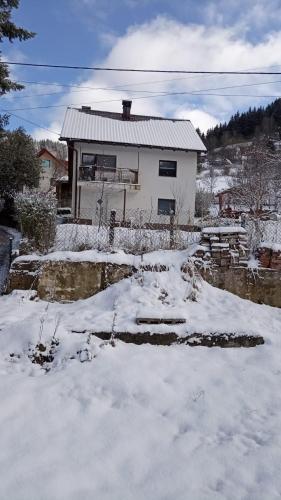 a house with snow in front of it at Vareš in Vareš
