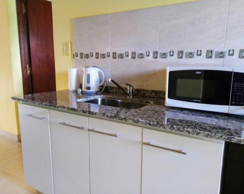 cocina con fregadero y microondas en Lo de Chavela en Salta