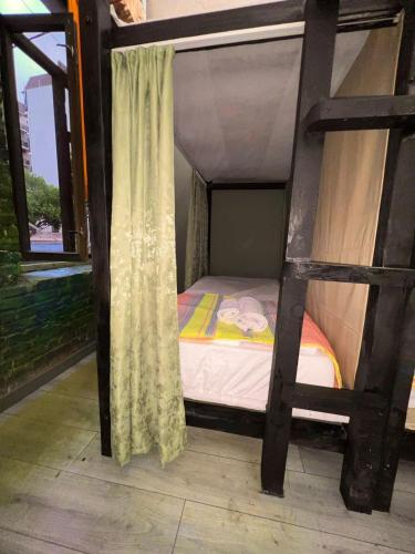a small bedroom with a bunk bed and a window at Communication hostel in Batumi