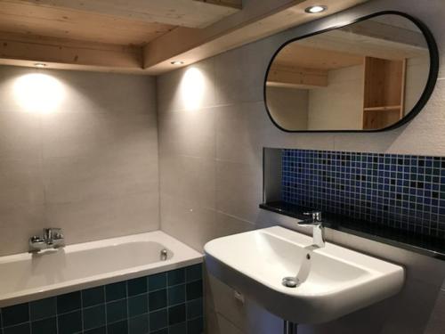 a bathroom with a sink and a mirror at Casa Vanellus / Vignogn / Val Lumnezia / near Laax in Vigens