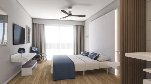 1 dormitorio con 1 cama y ventilador de techo en Blau Punta Reina, en Cala Mendia