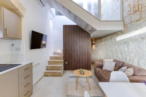 a living room with a couch and a table at Charming + Modern 1BR House in Historic Zebbug by 360 Estates in Żebbuġ
