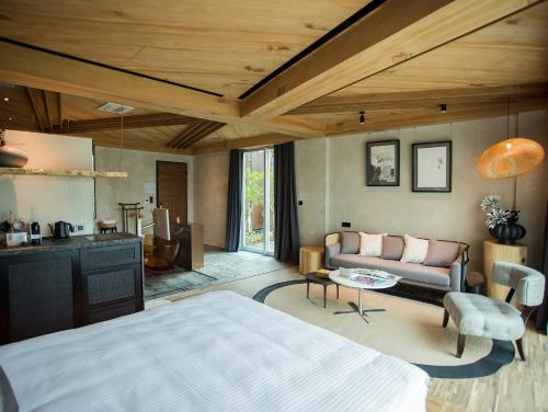 a bedroom with a bed and a living room at The Forest Museum in Zhuolan