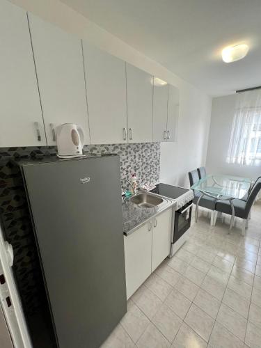 a kitchen with a refrigerator and a sink and a table at Marina2 in Belgrade