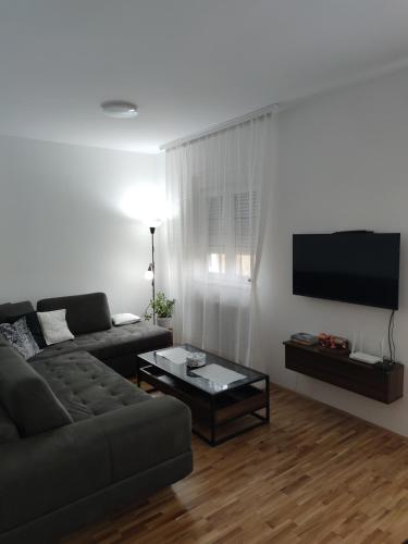 a living room with a couch and a coffee table at Apartman 022 in Smederevska Palanka