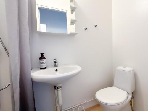 a bathroom with a sink and a toilet and a mirror at Strandgården Karlstad in Karlstad