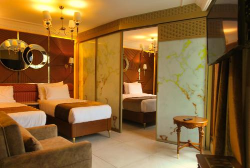a hotel room with two beds and a couch at Wyndham Istanbul Old City in Istanbul